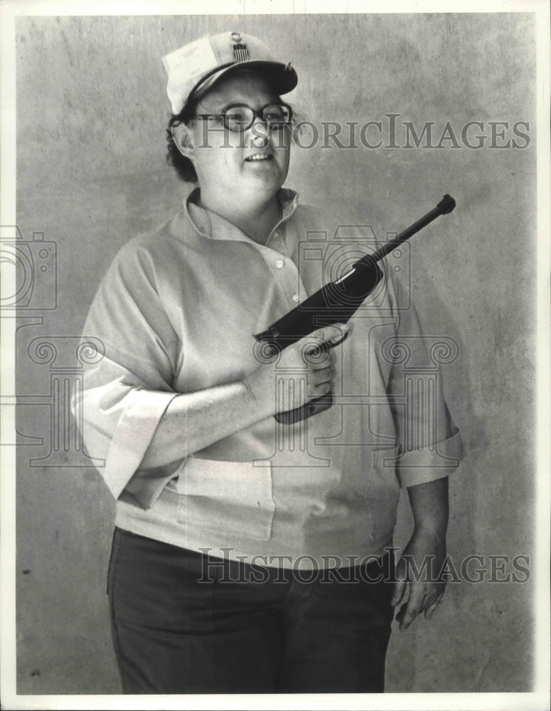 1977 Shooter Sallie Carroll displays a rifle  - Historic Images