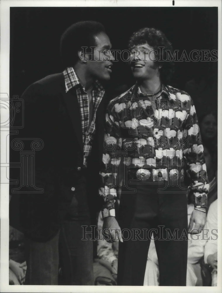 1975 Football player O.J. Simpson with singer Mac Davis - Historic Images