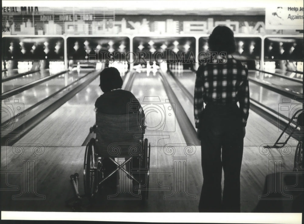 1979 Wheelchair bowler Skip Benson knocks down some pins - Historic Images