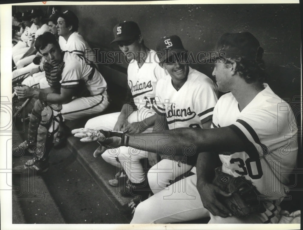 1986 Spokane Indians baseball players talking "shop" in the dugout - Historic Images
