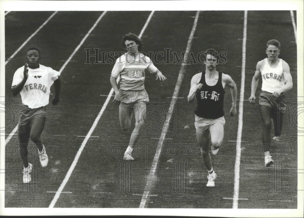 1988 Track runners Carlos Galland and Cory Misterek run the 100 - Historic Images