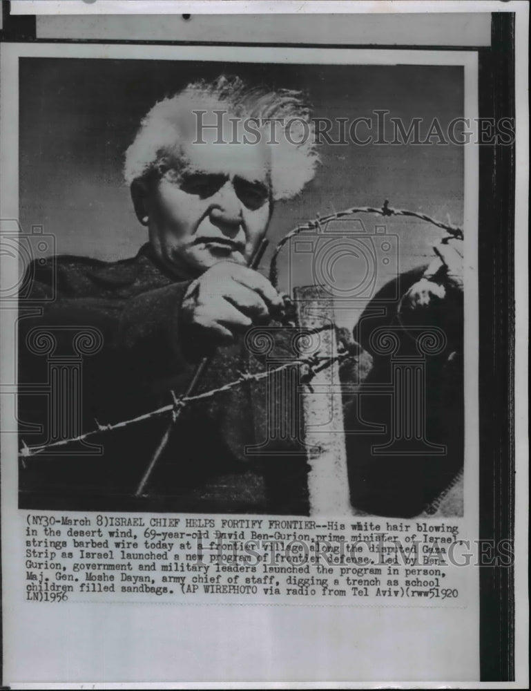 1956 Wire Photo David Ben Gurion, Israel Prime Minister strings barbed wire - Historic Images