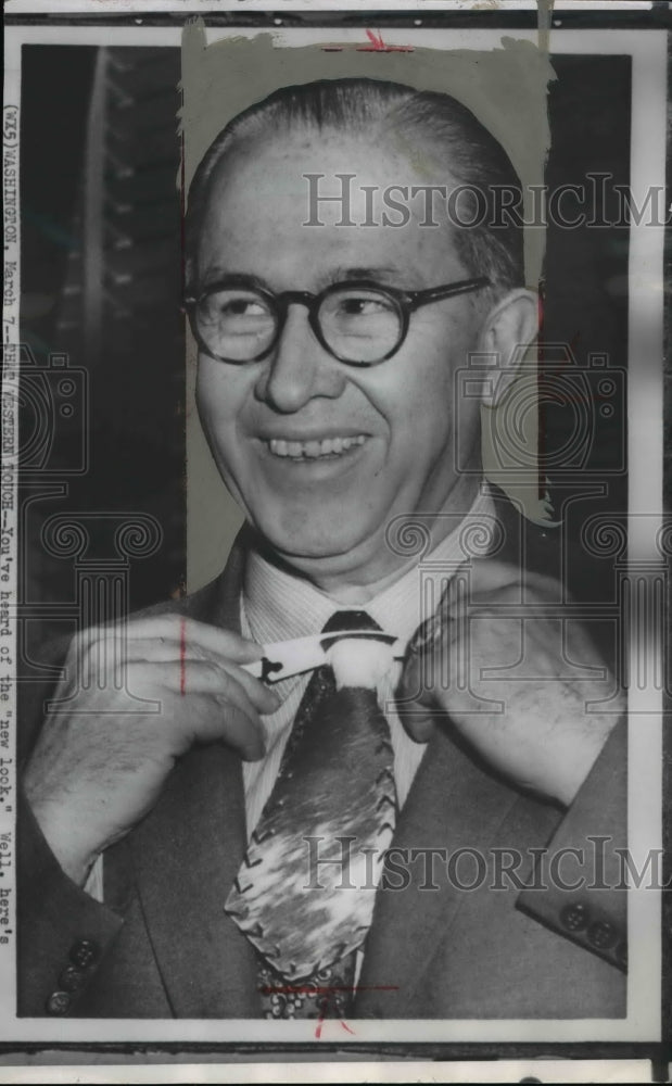 1958 Wire Photo Ezra Benson, secretary of agriculture, smiles as he fixes his t - Historic Images