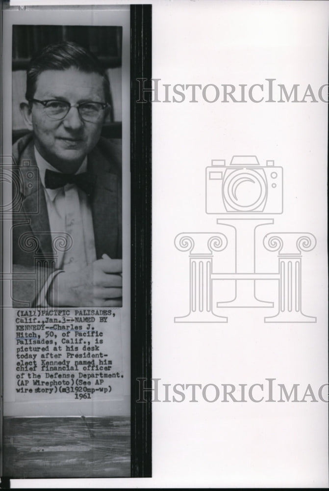 1961 Press Photo Charles J. Hitch posing at his desk - Historic Images