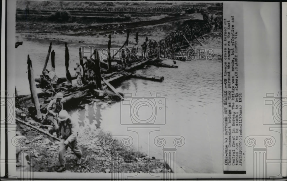 1951 Press Photo UN troops crossing a burned out bridge on East Central in Korea - Historic Images