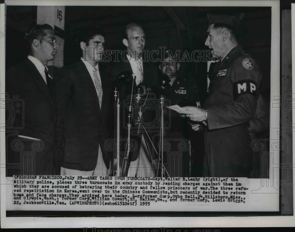 1955 Press Photo Capt. Walter R. Leahy places three turncoats in army custody - Historic Images