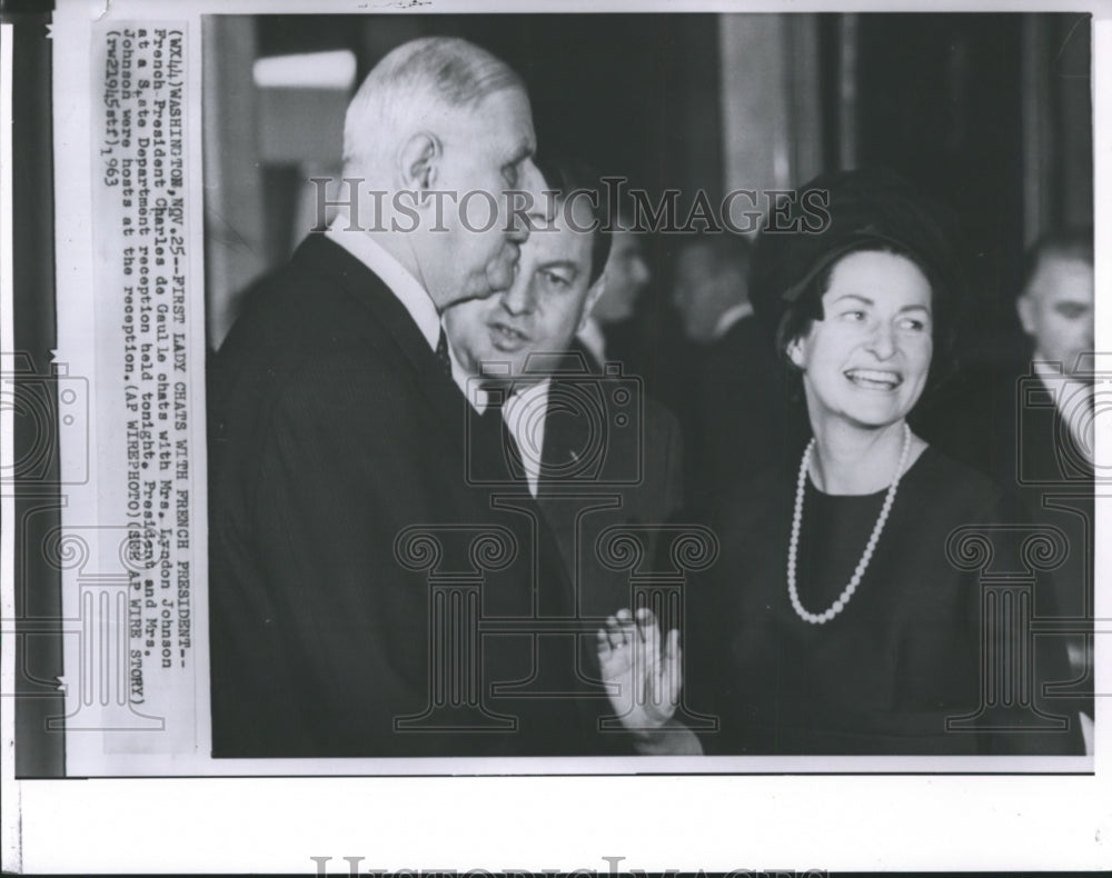 1963 French President Charles de Gaulle chats with Mrs. Johnson. - Historic Images