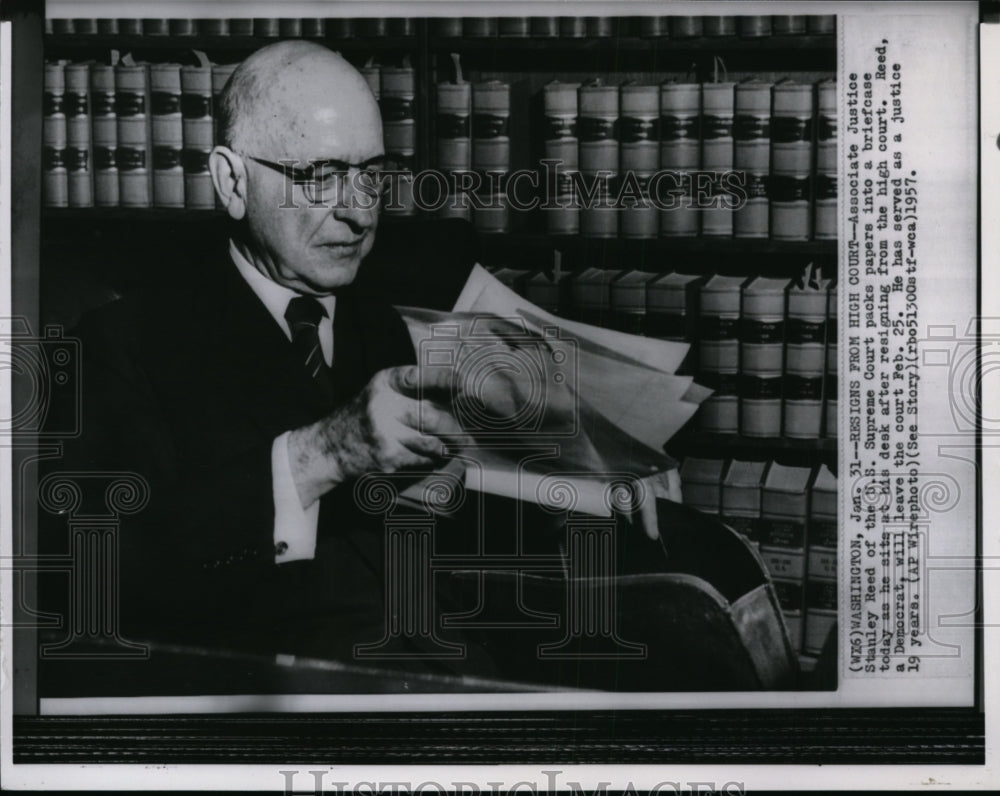 1957 Associate Justice Stanley Reed packs papers into a briefcase - Historic Images