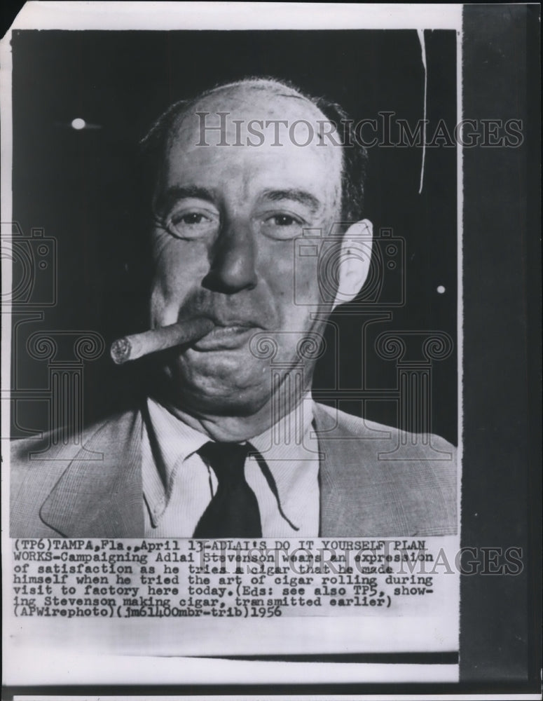 1956 Press Photo Adlai Stevenson tries a cigar that he hand rolled himself. - Historic Images