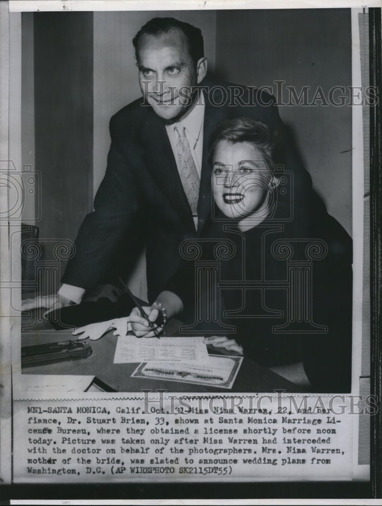 1955 Nina Warren &amp; fiance Dr. Stuart Brien get marriage license - Historic Images