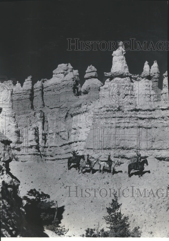 1937 Riders look at Queen Victoria formation of Bryce Canyon - Historic Images