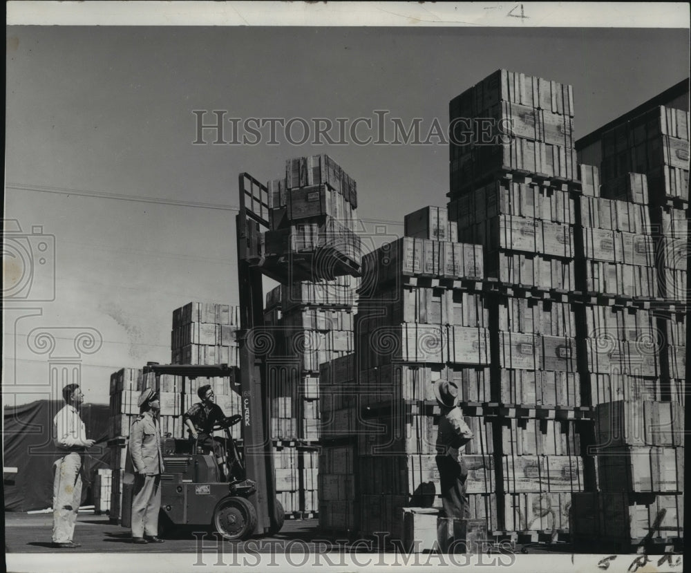 1944 Press Photo Operator Using a Fork Lift to Move Crated Oil Lubricants-Historic Images