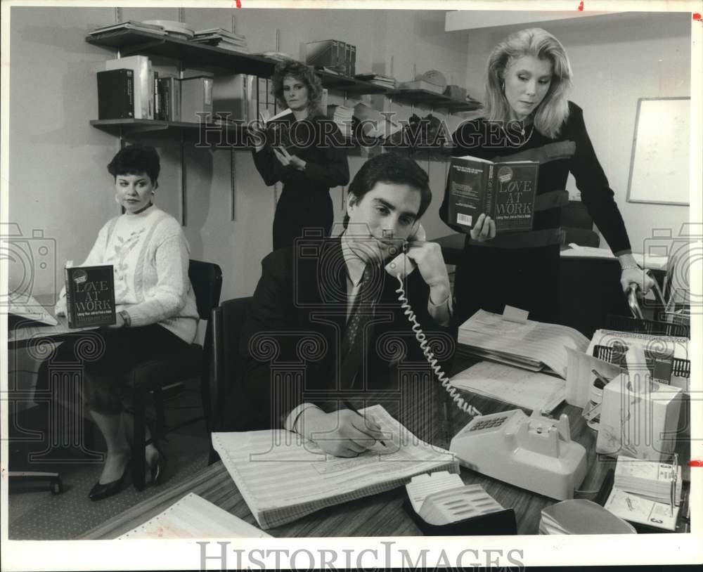 1988 Press Photo Models in &quot;Love at Work&quot; Office Romance Book Advertisement - Historic Images