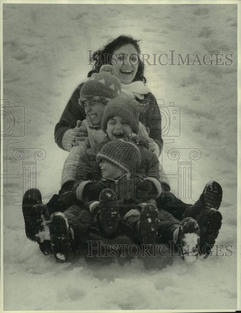 1984 Press Photo Children Sledding on Snowy Hill in Sleigh Ride Feature- Historic Images