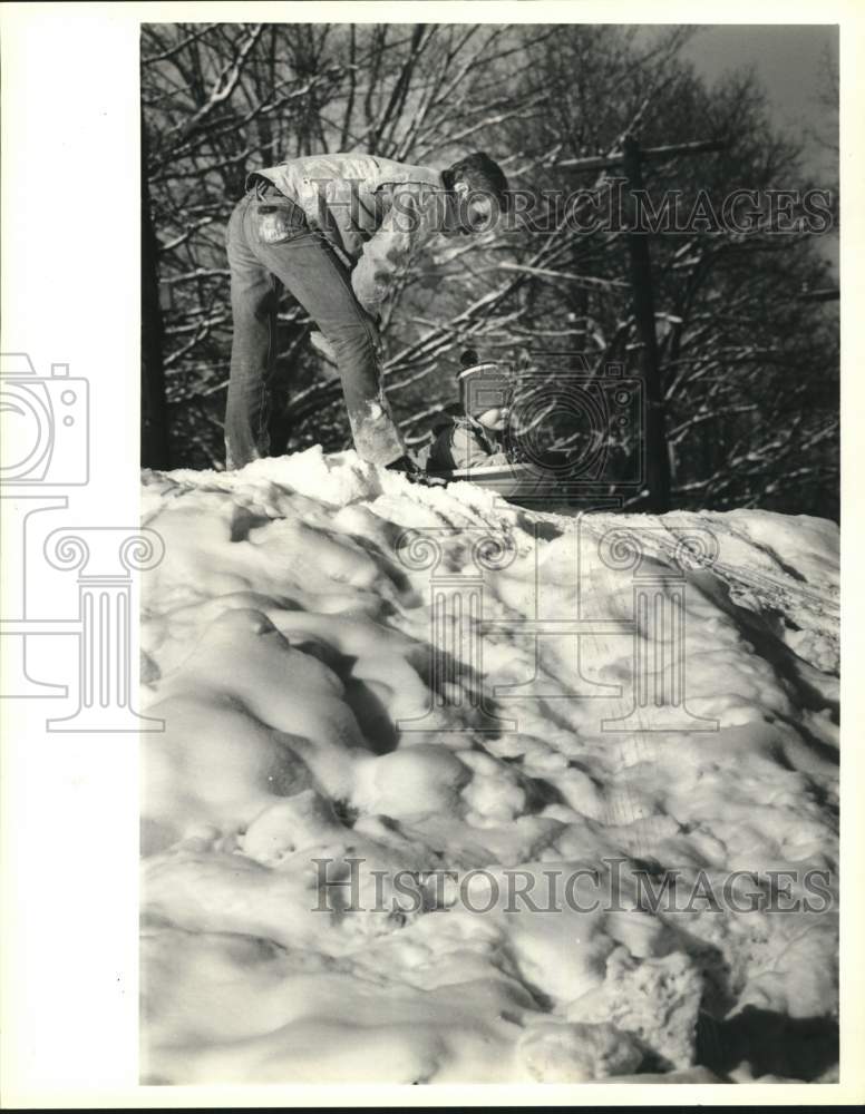 1989 Press Photo Jim and Trevor McIntyre Sledding at Chittenango Fire Department - Historic Images