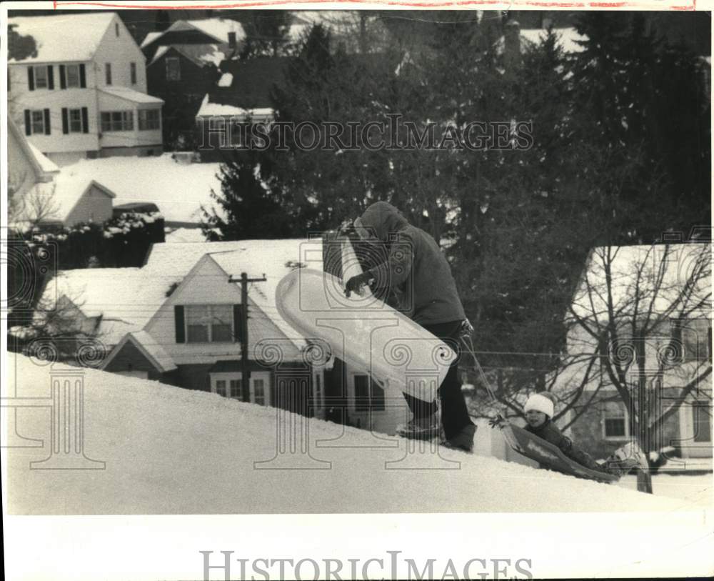 1988 Press Photo Canh Nguyen with son, Chau at Wescott Reservoir Sledding - Historic Images