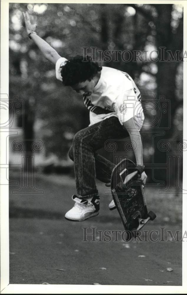 1988 Press Photo Ryan Callahan skateboards in Liverpool, New York on Tamarack - Historic Images