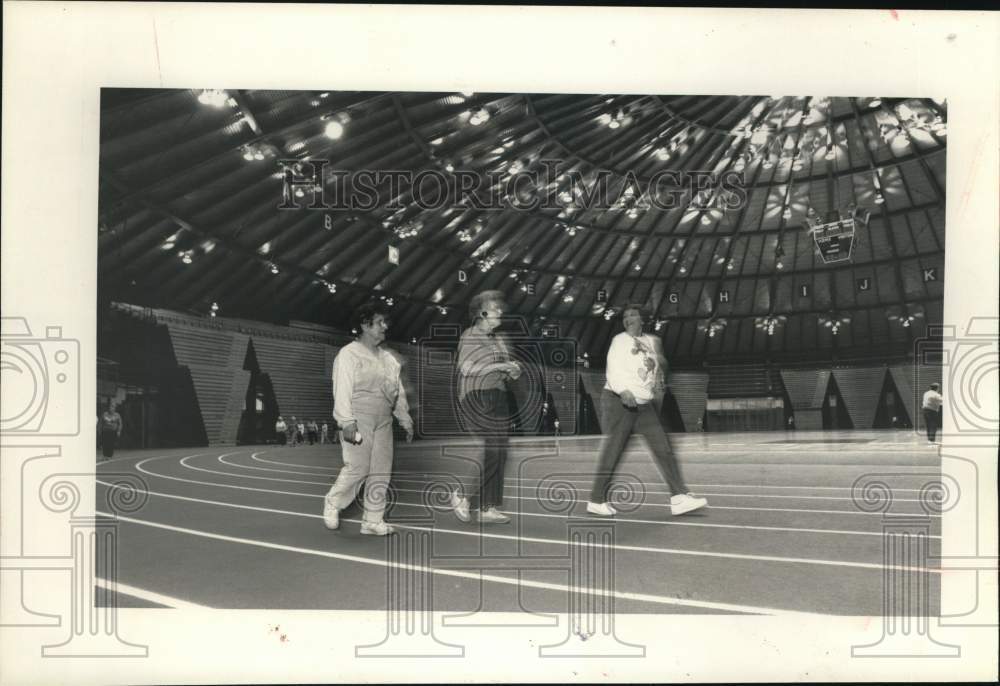 1989 Press Photo Senior Citizens Walking at Manley Field House Track - sya68330- Historic Images