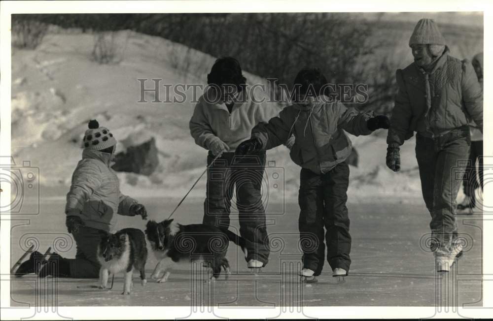 1987 Press Photo Girls Ice Skate with Dogs at Swan Pond in Manlius - sya71350 - Historic Images