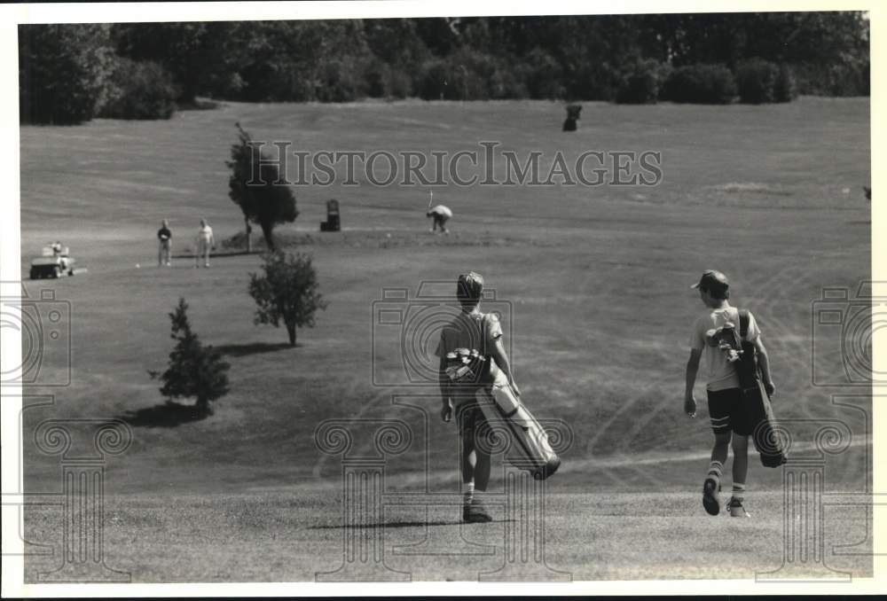 1990 Press Photo David Brown & Josh Trembly playing golf at Rusitc Golf Course- Historic Images