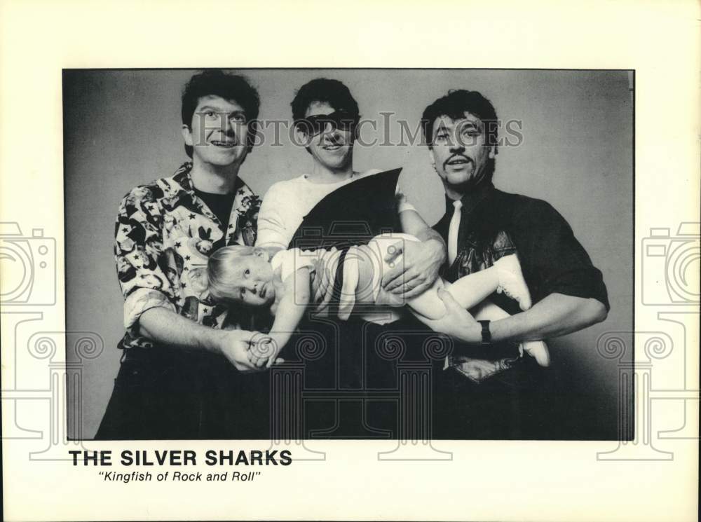 Press Photo Members of the music group The Silver Sharks hold a child - Historic Images