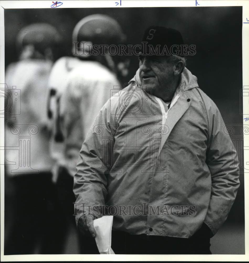 1987 Press Photo Football Dick MacPhearson paces Coyne Field at Game - Historic Images