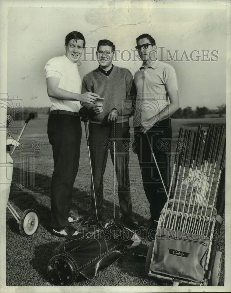 1967 A trio of male golfers pose next to their golf bags on course-Historic Images