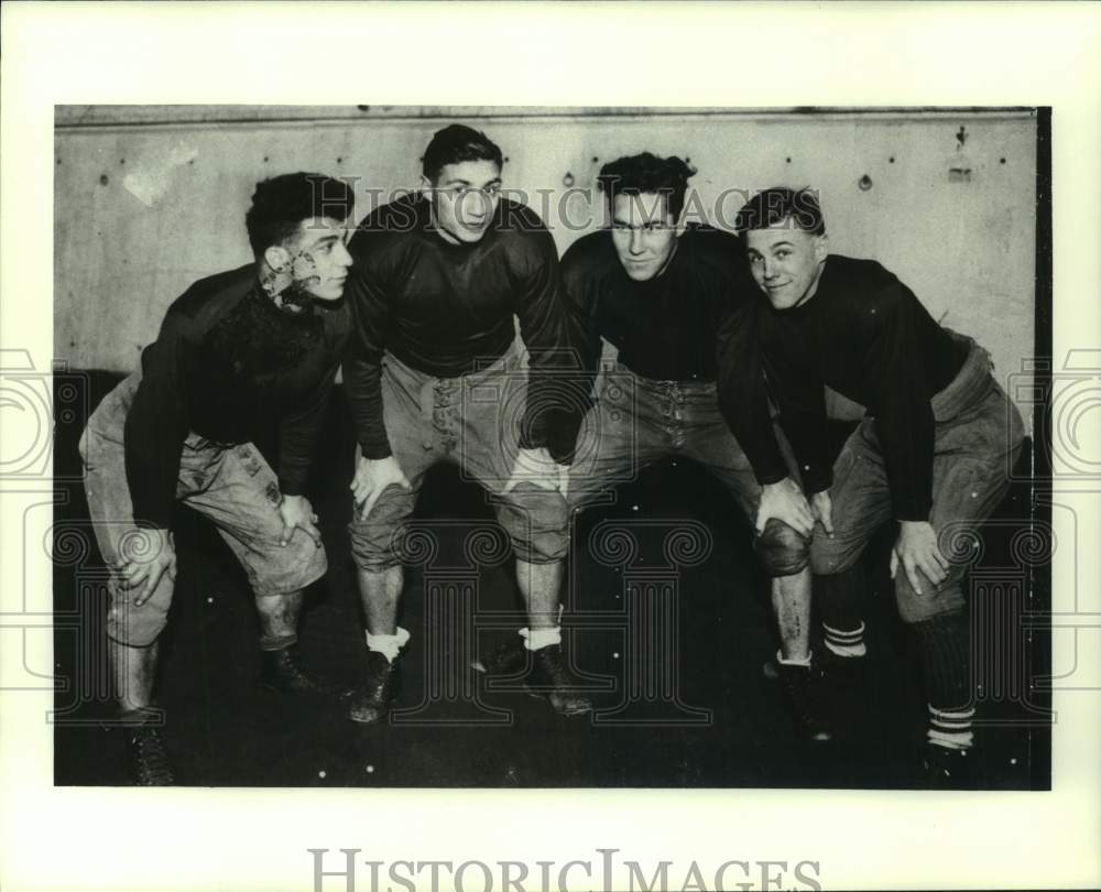 Press Photo Four football players pose together for photo - sys05718- Historic Images