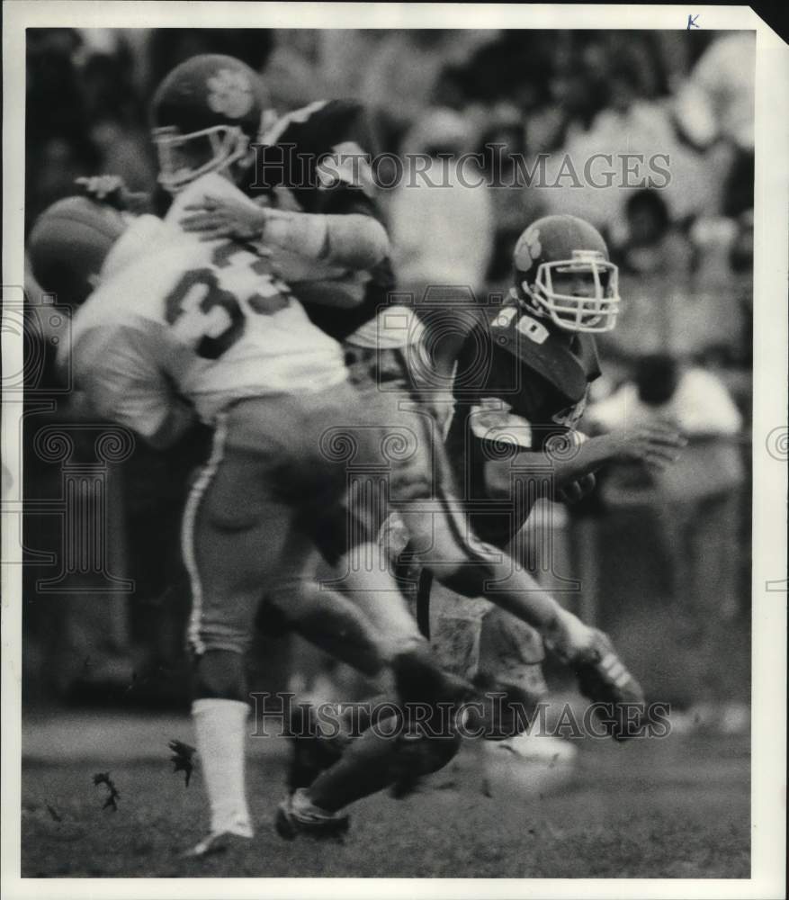 1987 Press Photo Corcoran football player Rick Williams slides around a block - Historic Images