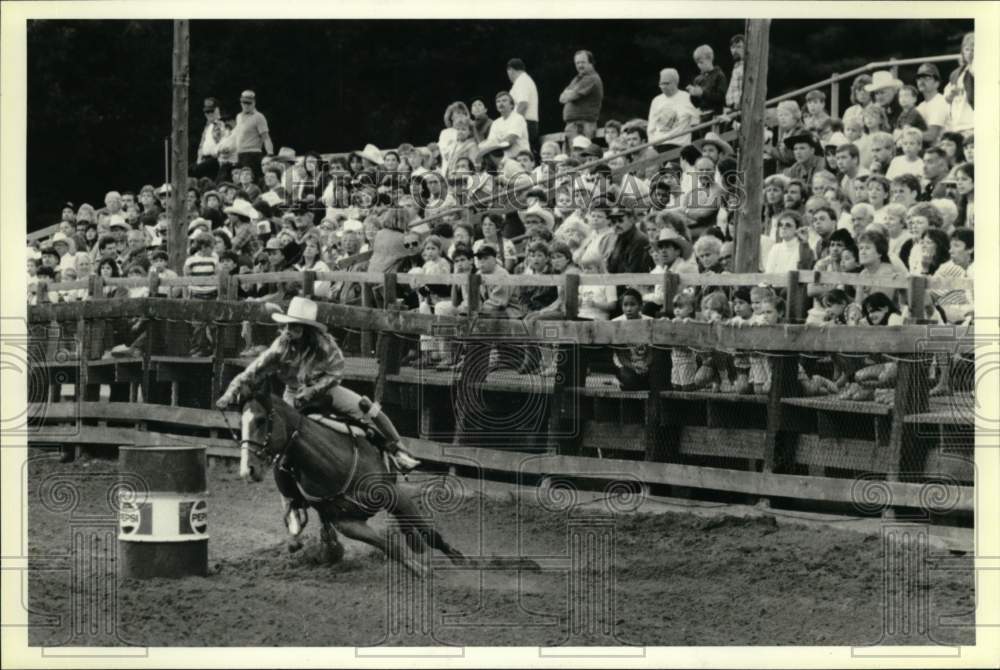 1989 Press Photo Man rides Horse around Barrels at Rodeo- Historic Images