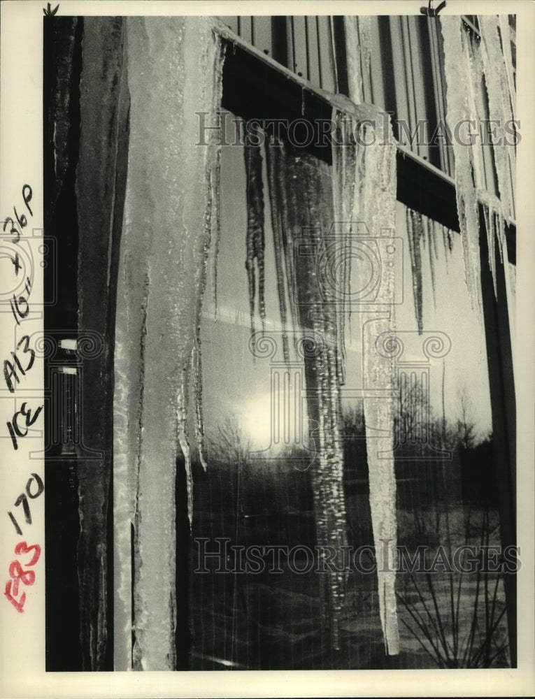 1983 Sunlight reflected in icicle-covered window - Historic Images