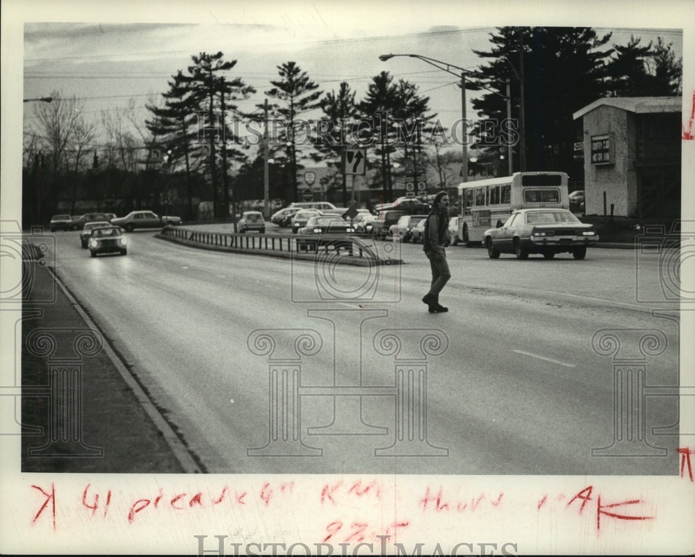 1980 Man walking across Wolf Road in Albany, New York - Historic Images