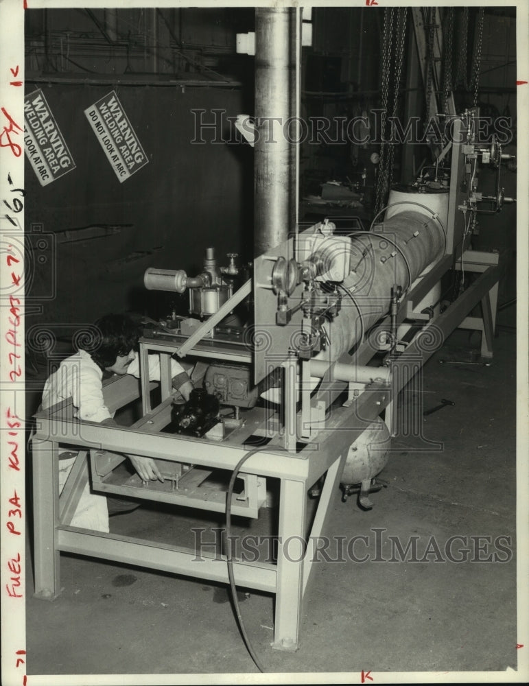 1978 Worker adjusts a bio-mass gassifier, Ballston Spa, New York - Historic Images