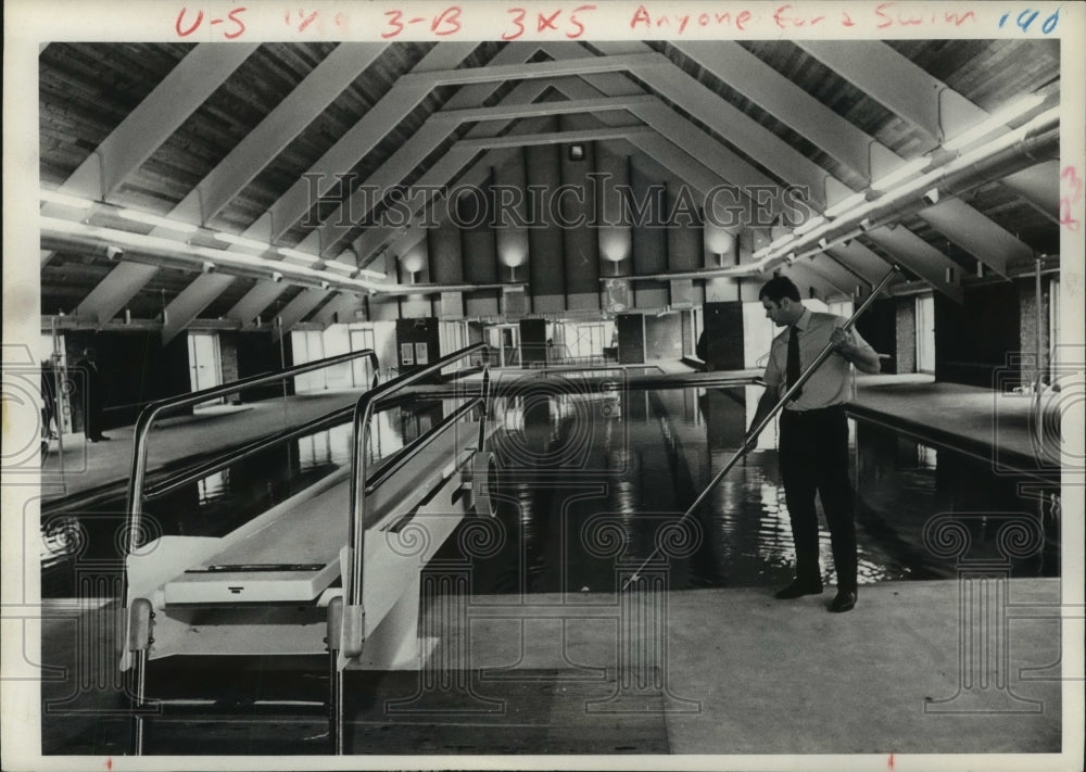 Walter Van Broklin, Jr., Program Physical Director, sweeping a pool-Historic Images