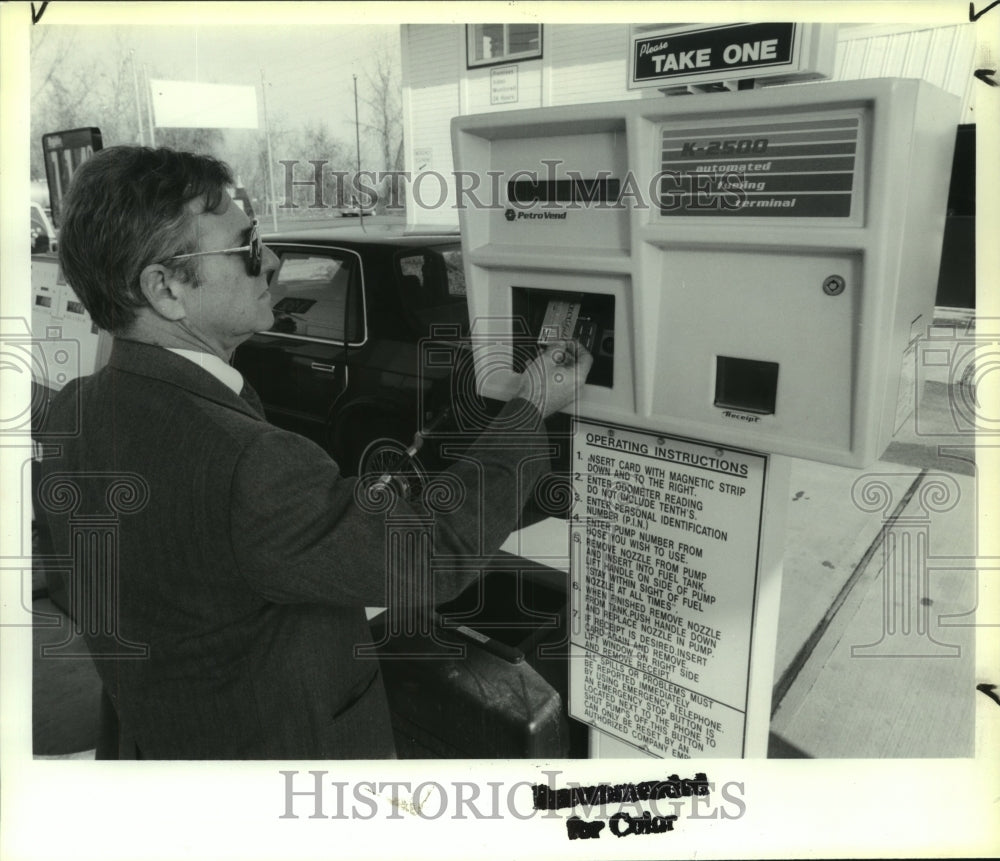 Press Photo Man uses Gasoline Station - tua03916 - Historic Images