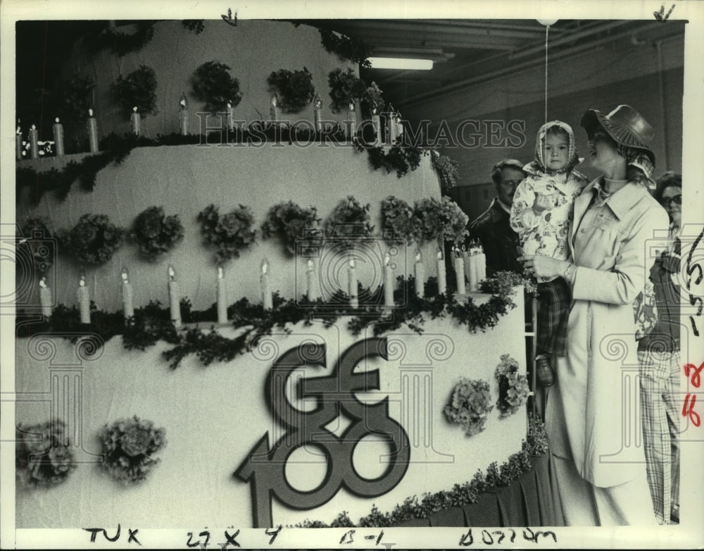 1978 People check out General Electric 100th Anniversary float, NY - Historic Images