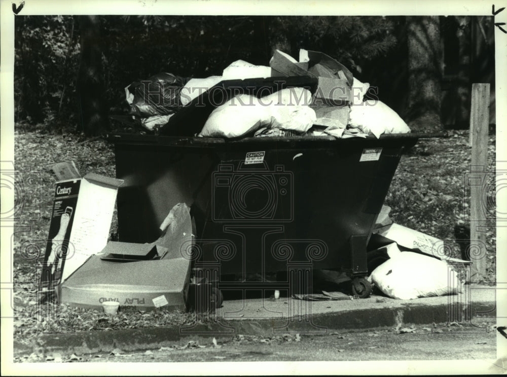1991 Overflowing garbage dumpster at Albany, New York apartments - Historic Images