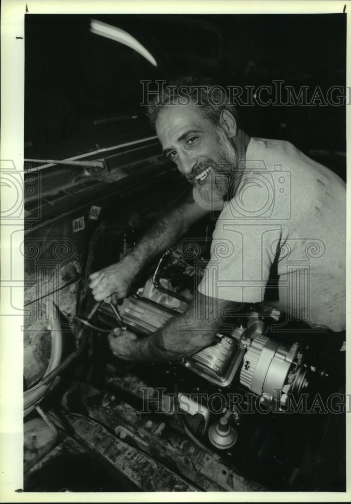 1993 Mechanic working on truck engine in Queensbury, New York garage - Historic Images