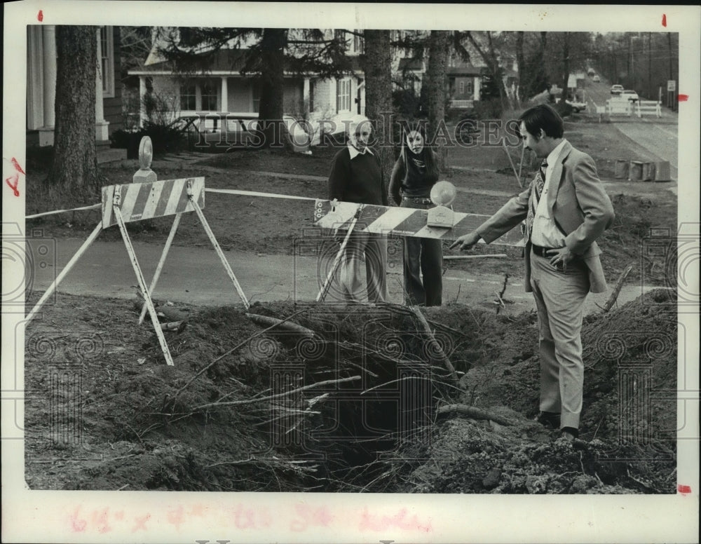1977 Richard Graft shows people severed tree roots, Niskayuna - Historic Images