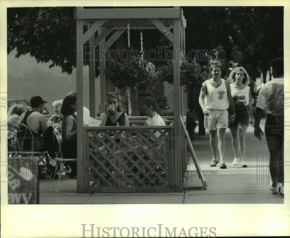 1993 Pedestrians walk past outdoor café on Broadway in Saratoga, NY - Historic Images