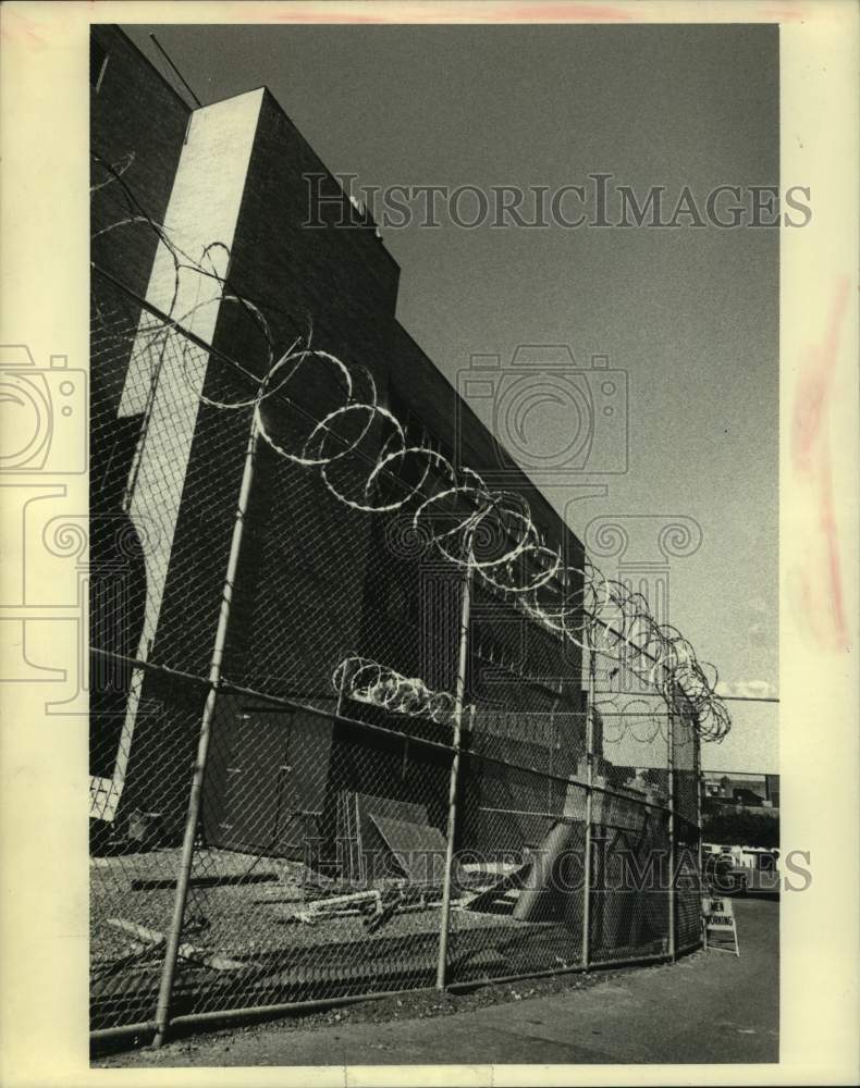 1984 Concertina wire tops fence at Schenectady, New York County Jail - Historic Images