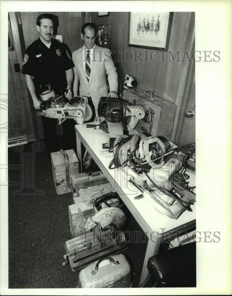 1990 New York police officers with recovered items from burglaries - Historic Images
