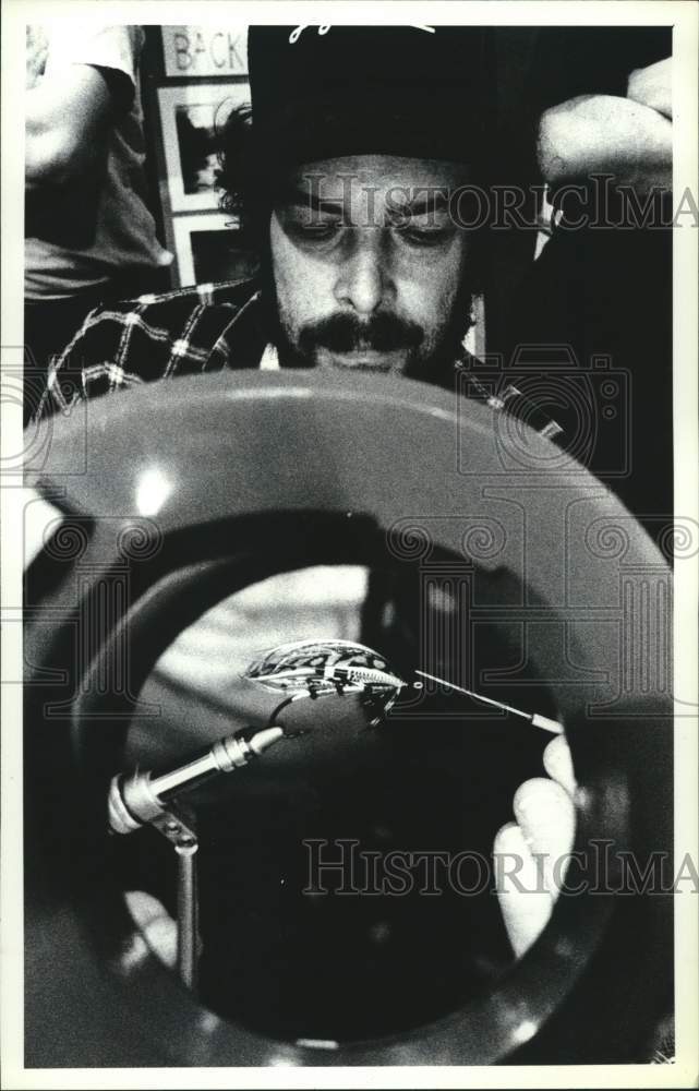 1990 Rick Whaley ties fishing lure at Albany, New York Wildlife Expo - Historic Images