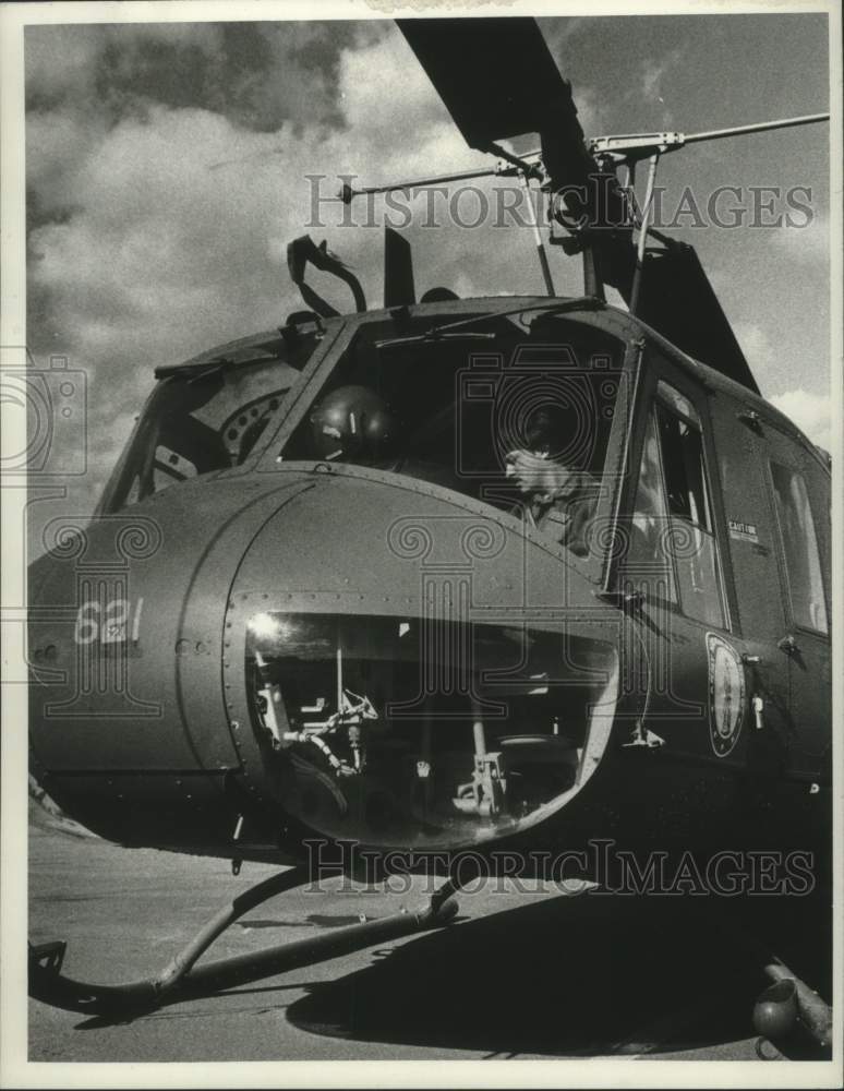 1977 Bob Nevins, in cockpit of helicopter - Historic Images