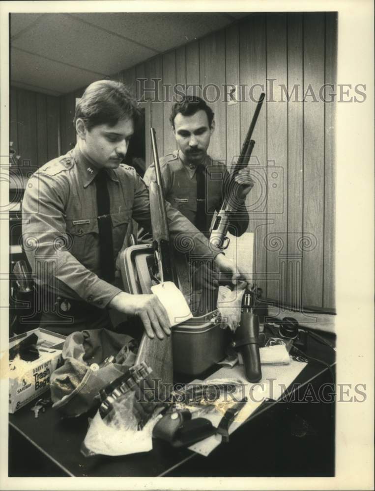 1984 Troopers display weapons seized from Rickie Nolen - Historic Images