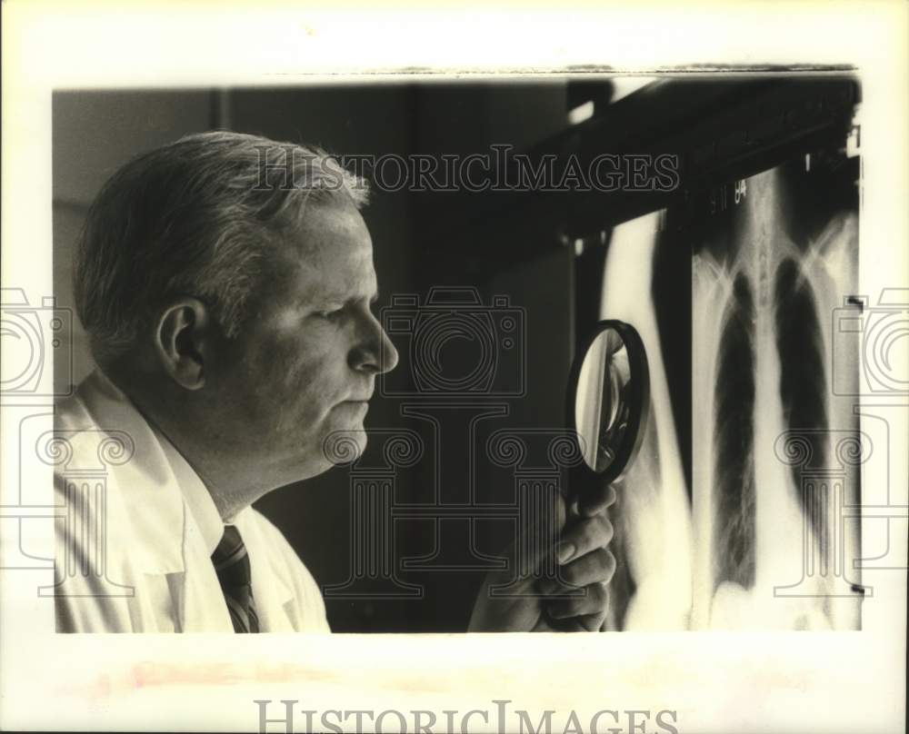 1984 Press Photo Arthur J. Wendte reviews a chest radiograph - tua13705 - Historic Images