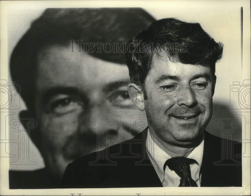 1977 Press Photo Senator Howard Nolan standing in front of photograph of himself - Historic Images
