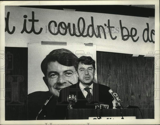 1977 Press Photo Senator Howard Nolan standing in front of photograph of himself - Historic Images