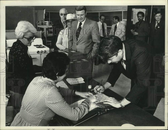 1977 Press Photo Howard Nolan signing form as others look on - tua14177 - Historic Images