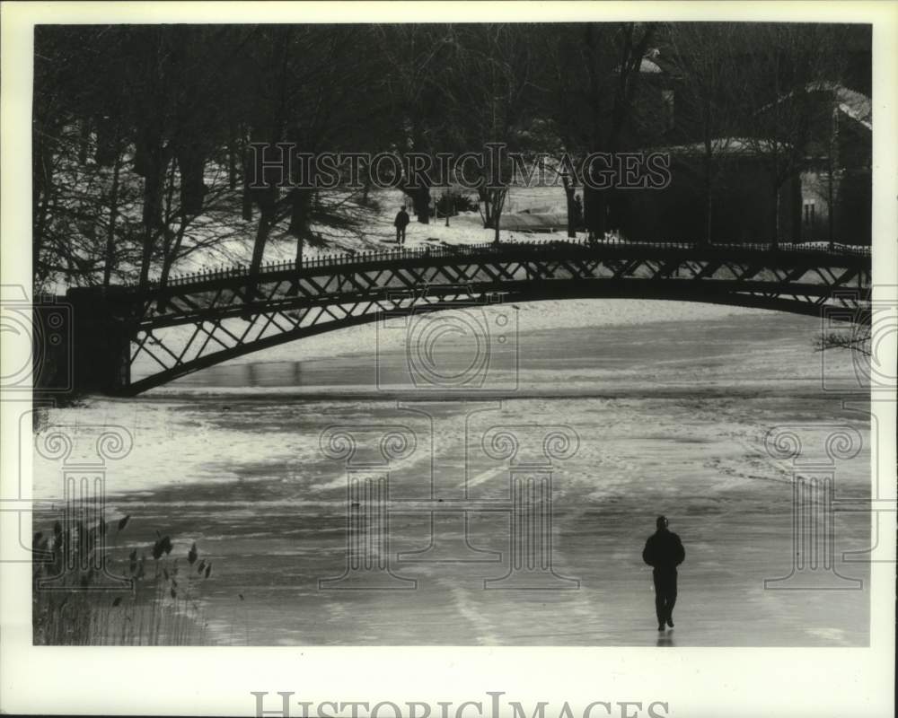 1994 Unknown man takes short cut across ice at Washington Park Lake - Historic Images